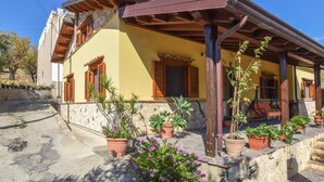 A yellow building with wooden shutters and a covered porch. - Beautiful home in Reggio Calabria (Reggio Calabria)