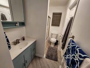Combined shower/bathtub, towels, soap, toilet paper