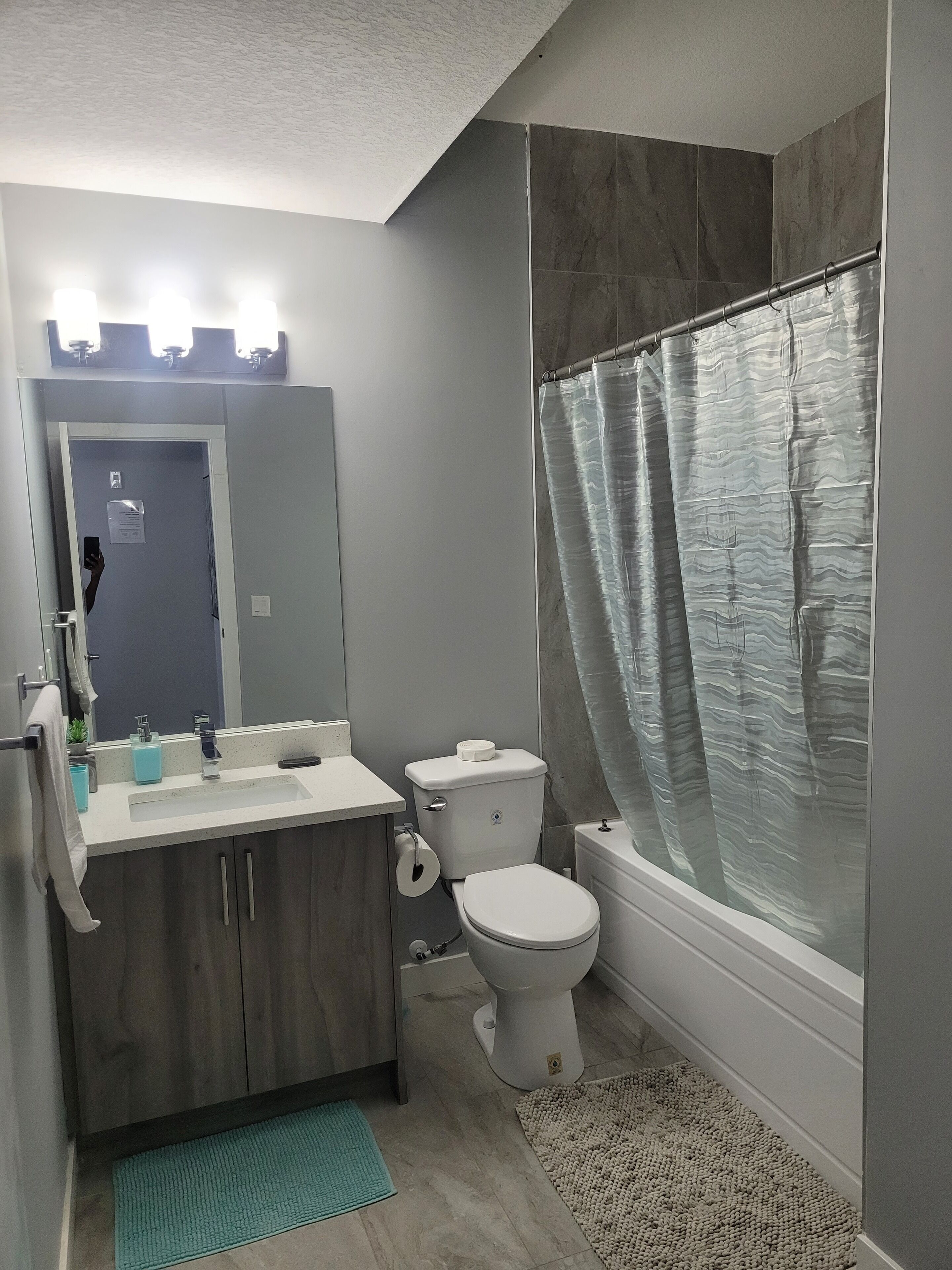 Combined shower/tub, hair dryer, towels, soap
