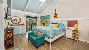 A bedroom with a bed, a ceiling fan, a guitar, a small table, and a window with curtains. - Peaceful Mountain Retreat- Jungle Mountain Vibes (Holualoa)