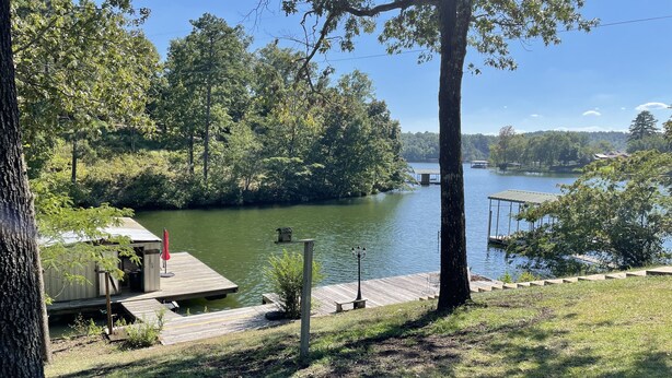 A lakeside property with a dock, a small shed, and a gazebo. - Lake Hamilton, BoatHouse, Hot Tub, 
Barge Rental, Sleeps 10, H.S. National Park (Hot Springs)