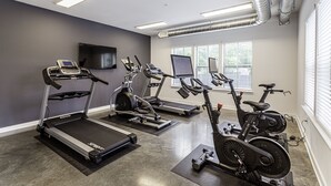 A gym with treadmills, elliptical machines, and stationary bikes. - Beautiful 1BR in Midtown and the Medical District  (Memphis)