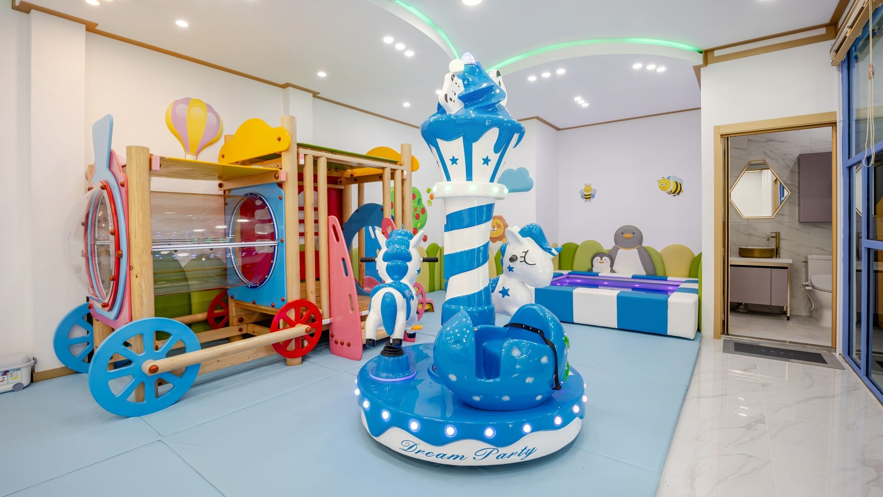 A children's play area with a carousel, a ship-themed play structure, and a Dream Party ride.