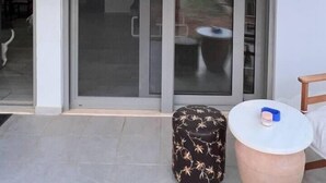 A modern interior with a sliding glass door leading to a patio area. - Charming House in Souda, near Chania, Crete (Souda)