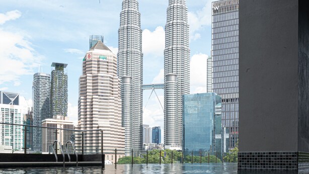 A modern building with a unique architectural design, featuring a series of cylindrical towers and a glass facade.