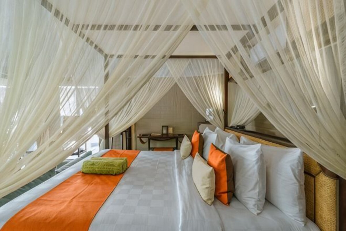 A room with a bed, a table, and a chair.