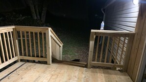 A wooden deck with a ramp leading to a house. - Scenic Mountain Views 4 Bed 2 Bath (Cave Spring)