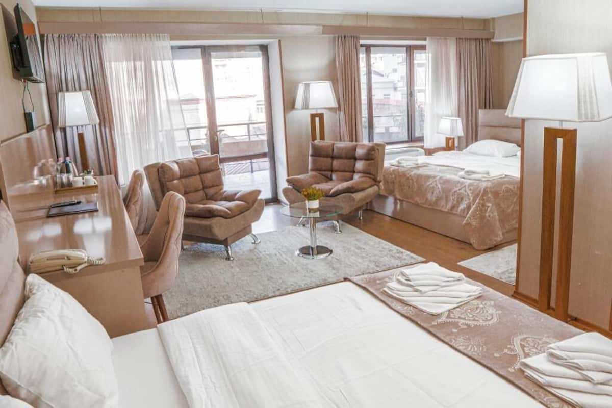 Deluxe Quadruple Room | Desk, laptop workspace, iron/ironing board (on request), cribs (free)
