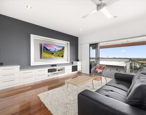 High ceilings, bold colour, and a dining table for eight — this living space was built for groups who like to gather.