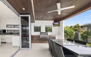 High ceilings, stone benchtops, double ovens, and a wine fridge built into the island — this kitchen means business. - Sandy View - 180 degree views - Luxury Home (Nikenbah)