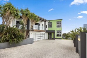 The full picture — a generous multi-level home with private pool, double garage, and a coastal backdrop that seals the deal.