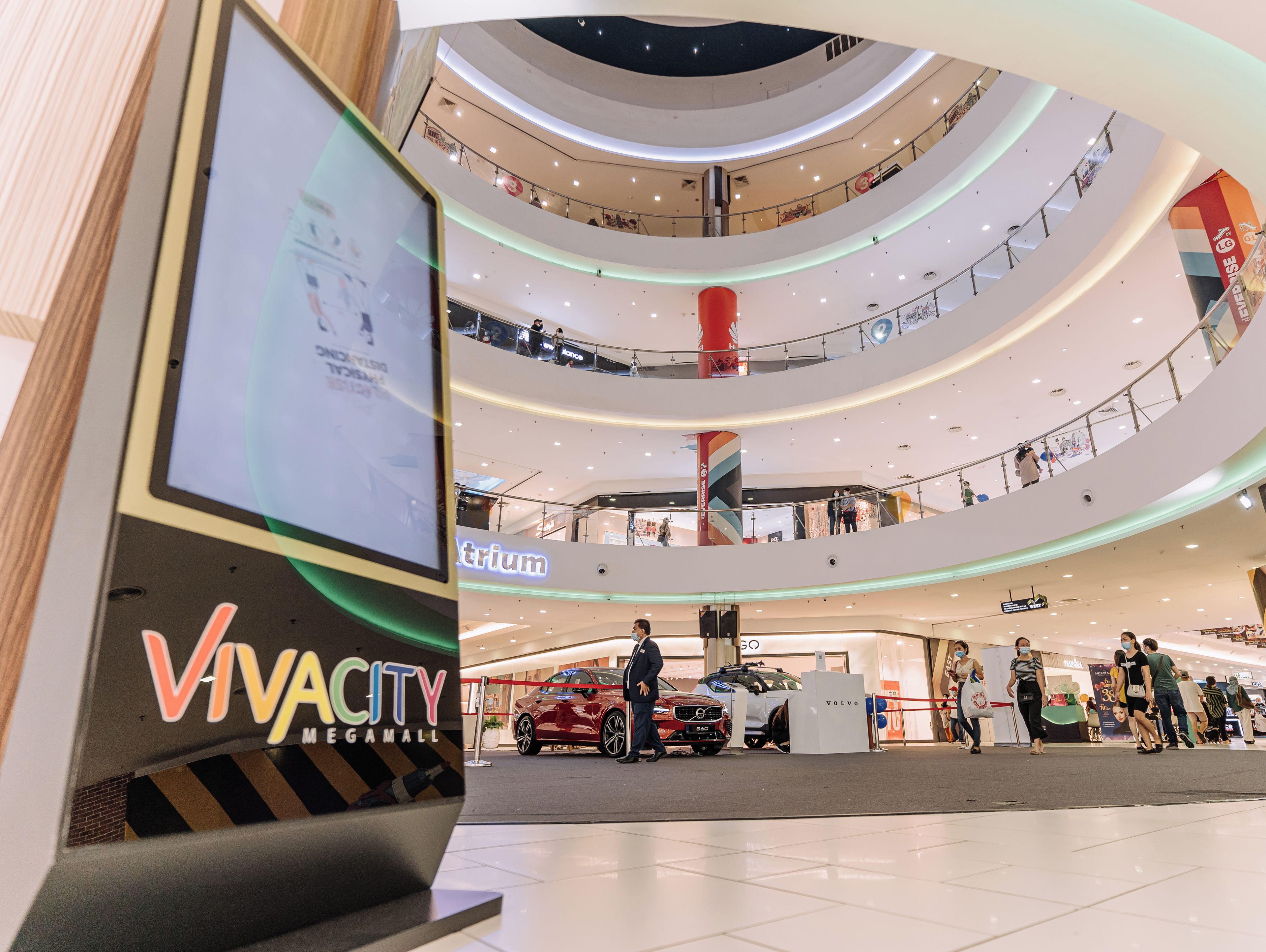 A multi-level shopping mall with a prominent 'VivaCity Megamall' sign, multiple floors, and a central atrium.