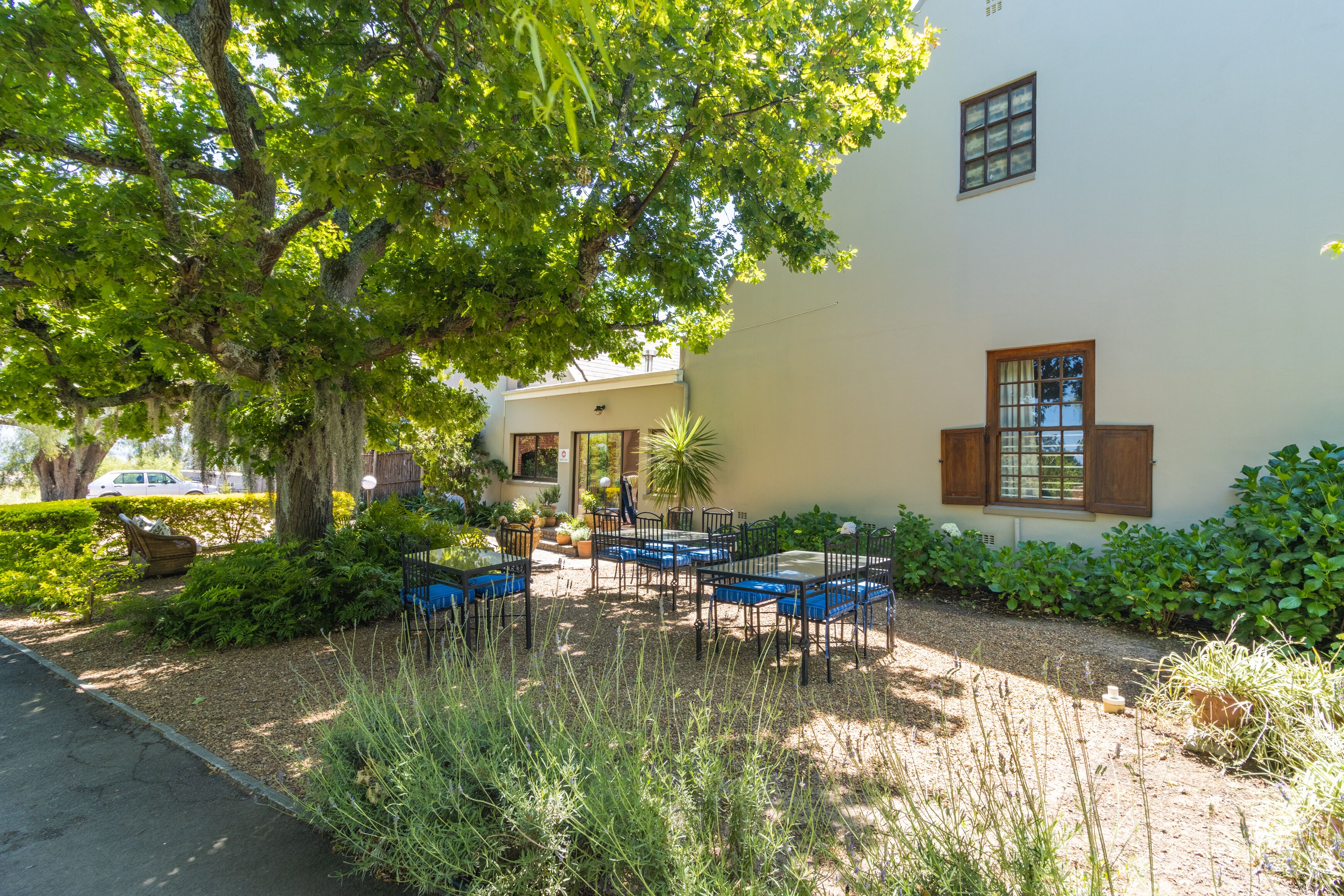 A patio area with outdoor seating and a building in the background.