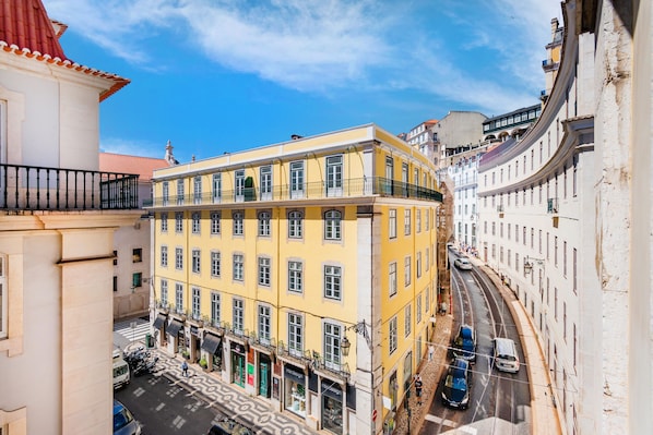 Stroll out onto the charming balcony with black railings and take in the sights of the bustling city below.