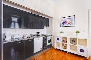 Enjoy cooking in this well-equipped kitchen with dishwasher, sleek cabinetry, and large window.