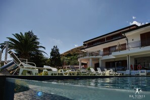 Relax by the pool with a clear view of the surrounding landscape, surrounded by lounge chairs and a lifebuoy.