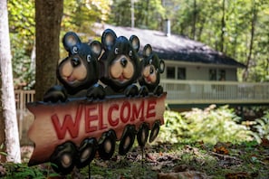 A wooden welcome sign with bear figures and the word "WELCOME" in red letters. - Quiet Resort Cabin, Screened HotTub, Fast WiFi, 3 Resort Pools, 24 Hour Security (Gatlinburg)