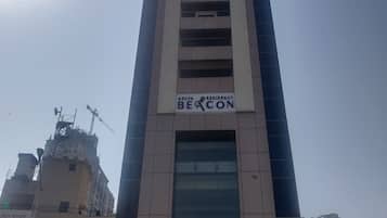 A tall building with a sign reading "Adiva Residency Beacon".