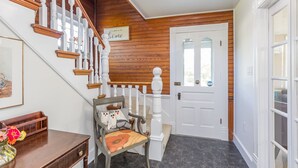 A staircase with wooden railings and a white door with glass panels. - Charming Gingerbread House. Awesome mountain views near to SNP and Skyline Dr. (Penn Laird)