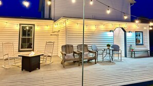 A white house with a wooden deck, string lights, and outdoor furniture. - Charming Gingerbread House. Awesome mountain views near to SNP and Skyline Dr. (Penn Laird)