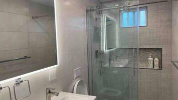 Shower, rainfall showerhead, hair dryer, towels