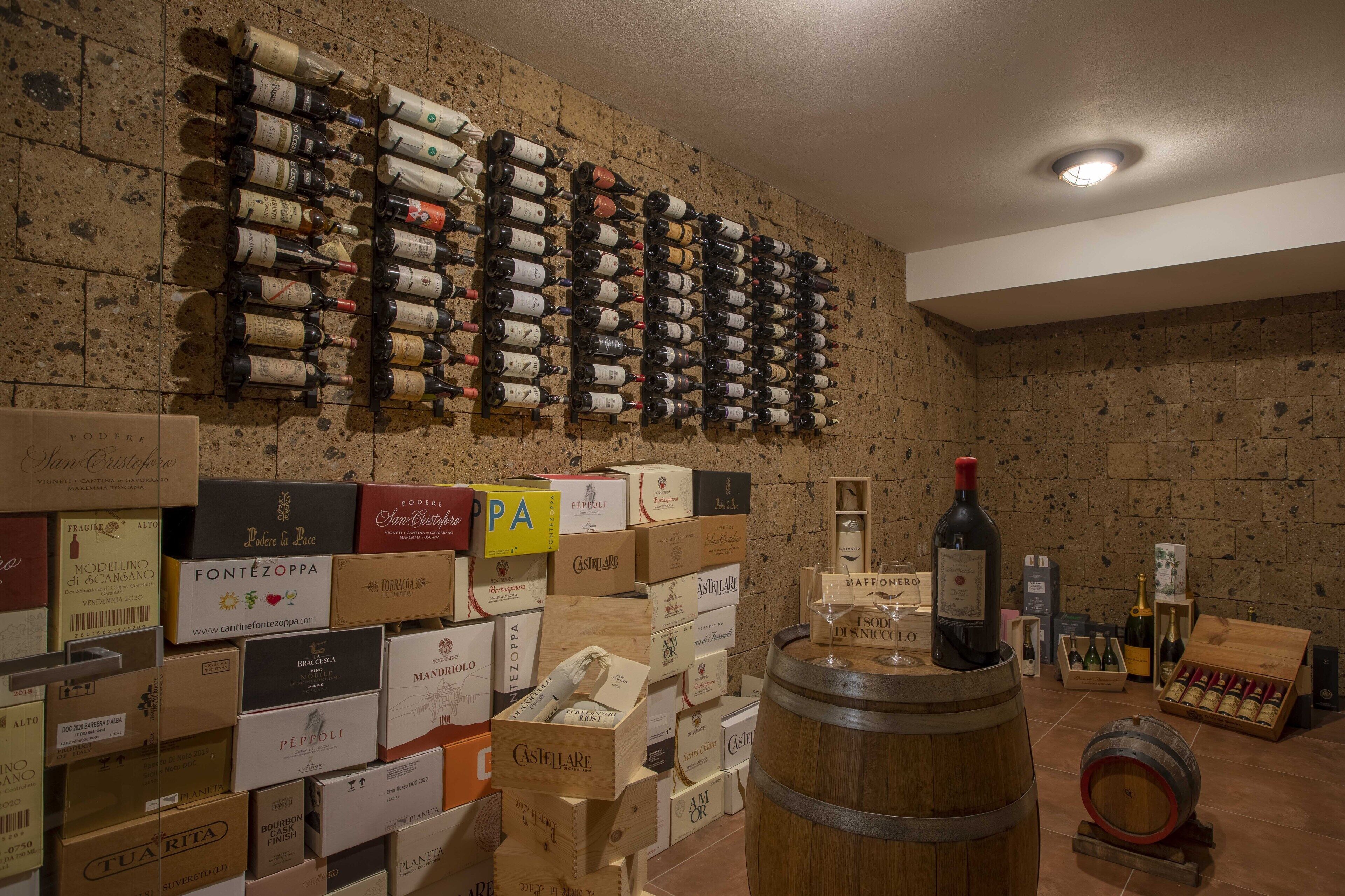 A wine cellar with numerous wine bottles and boxes.