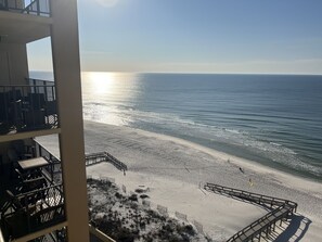 A beach view from a balcony with a wooden deck and a sandy beach in the foreground. - 3BR/2BA panoramic views/Gulf of Mexico (Orange Beach)