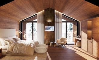 Un dormitorio con una cama grande, una silla y una mesita. Cuenta con un balcón con vistas a árboles.