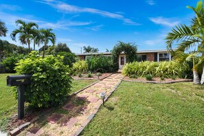 Stroll through the beautifully landscaped grounds, surrounded by lush greenery and palm trees.
