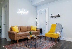 Relax in the Lockhart living room with a sofa, armchair, and coffee table.