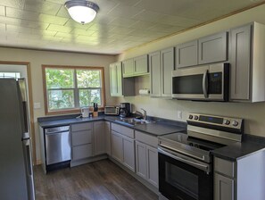 Fridge, microwave, oven, stovetop - 2-Bedroom Cottage On Lake Ainlsie Private Beach, Enjoy Fishing & Swimming. (INVERNESS)