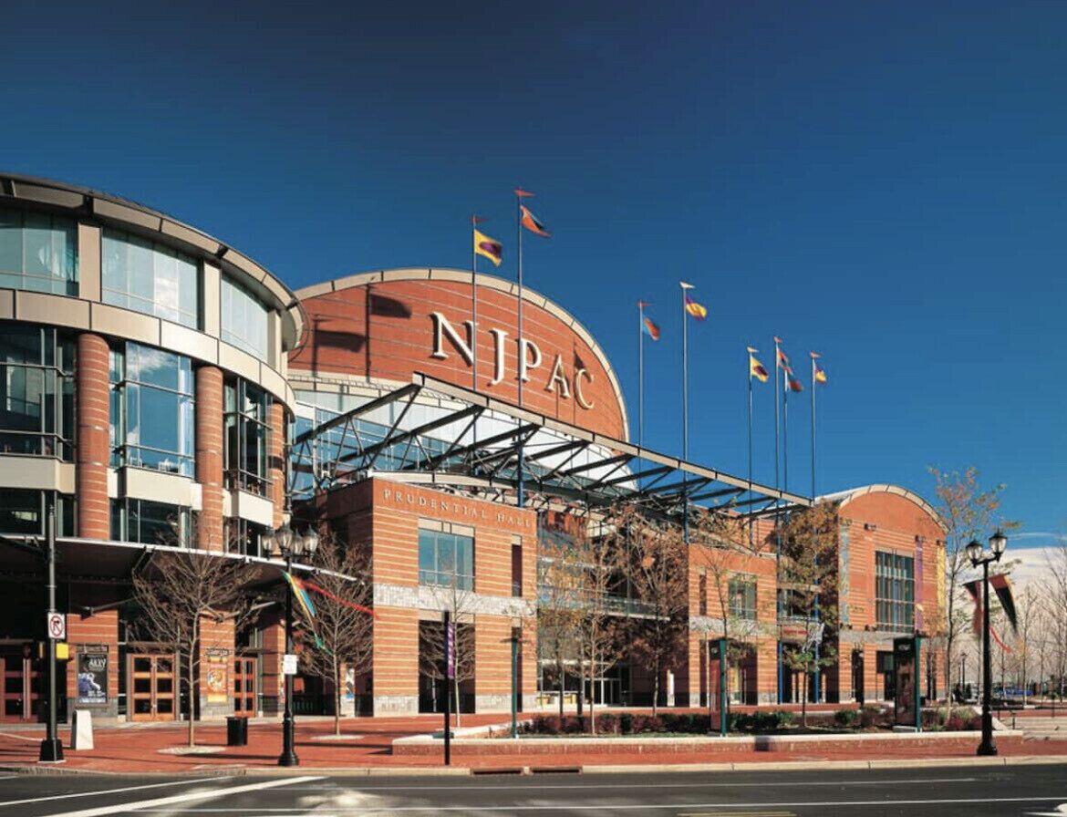 A modern building with a prominent 'NJPA' sign, featuring a mix of brick and glass architecture, and a covered entrance area.