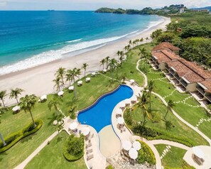 A resort with a swimming pool, beach, and ocean views. - Palms 23 (The Palms)