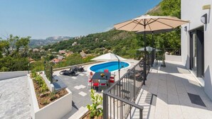 A rooftop pool area with a view of the surrounding landscape.