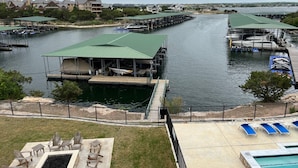 A marina with docks, a swimming pool, and outdoor seating. - Possum Kingdom Lake Luxury, Upgraded Lakefront Condo w Breathtaking Water View (Graford)