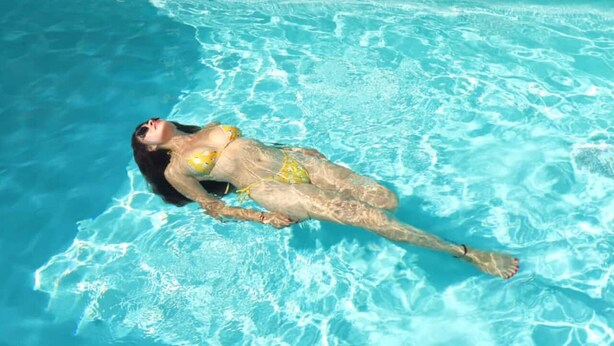 A person floating in a clear blue pool. - Relaxing Getaway w/ Pool, Billiards, Steps to the Beach – Perfect for Families! (Puerto Peñasco)