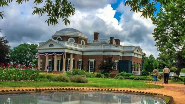 A large, historic building with a central dome and symmetrical architecture, surrounded by a well-maintained garden and a circular water feature. - Relaxing Wintergreen Chalet (Wintergreen Resort)
