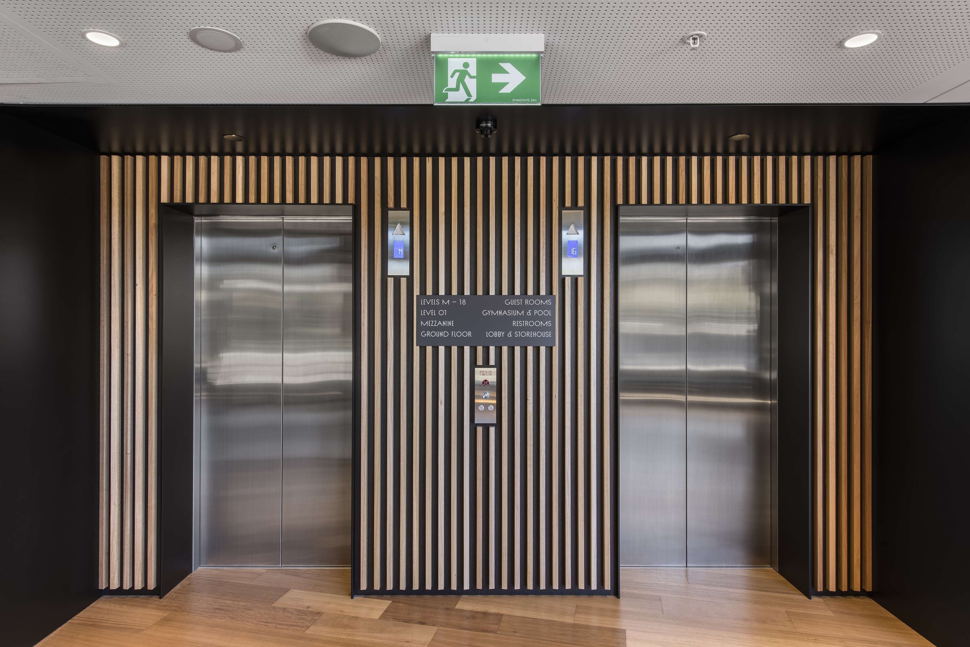 An elevator with a sign indicating levels and amenities.