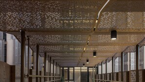 A modern indoor pool with a chevron pattern floor, surrounded by wooden railings and a patterned ceiling. - Vibe Hotel Adelaide (Adelaide)