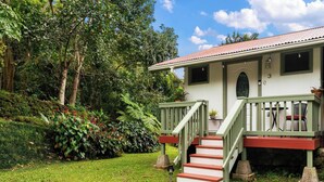 A house with a porch, steps, and a number '3' on the wall. - Adorable Cottage w/ Jungle & Mountain Vibes (Holualoa)