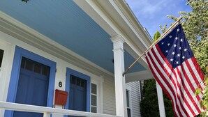 A house with a blue door, a mailbox, and an American flag on the porch. - 1-bedroom in the Borough, just steps to the water (Stonington)