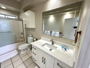 Bathtub, towels, soap, toilet paper