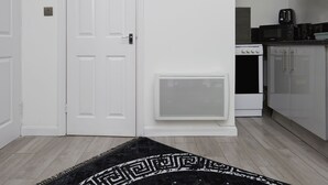 A modern kitchen with white cabinets, a microwave, and a coffee maker. - Hayy Vibrant Studios Queensgate (Huddersfield)