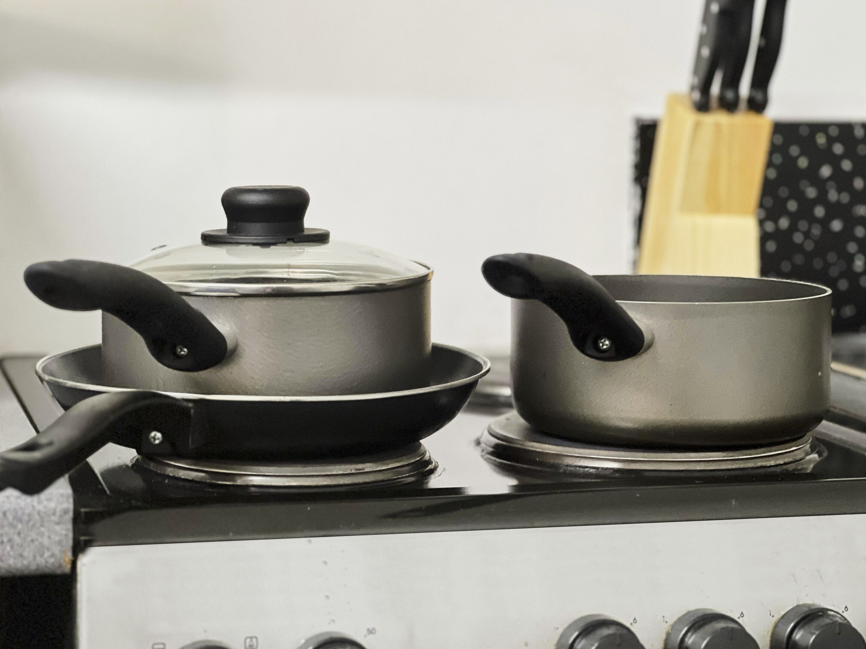 A stove with two pots and a pan on it.