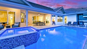 A modern pool area with a hot tub, outdoor seating, and a covered patio. - Hot Tub & Heated Pool, 8 Bikes, 2 King Beds and Suites! (Marco Island)