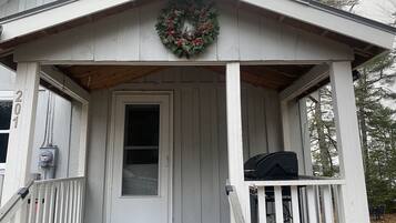 A house with a porch, a door, and a wreath.