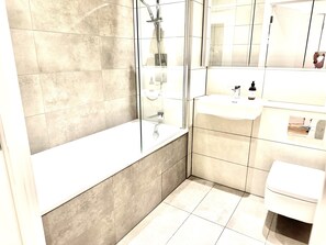 Combined shower/bathtub, hair dryer, towels, soap