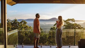 A couple standing on a balcony with a view of a forest and mountains. - Wilderness House l Infinity Pool & Views (Kulangoor)