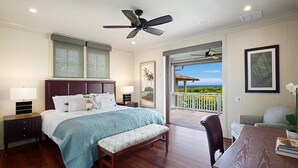 A bedroom with a bed, bedside tables, a bench, a ceiling fan, and a balcony with a view. - Gorgeous Poipu Villa with Pool & Spa + Ocean Views (Koloa)