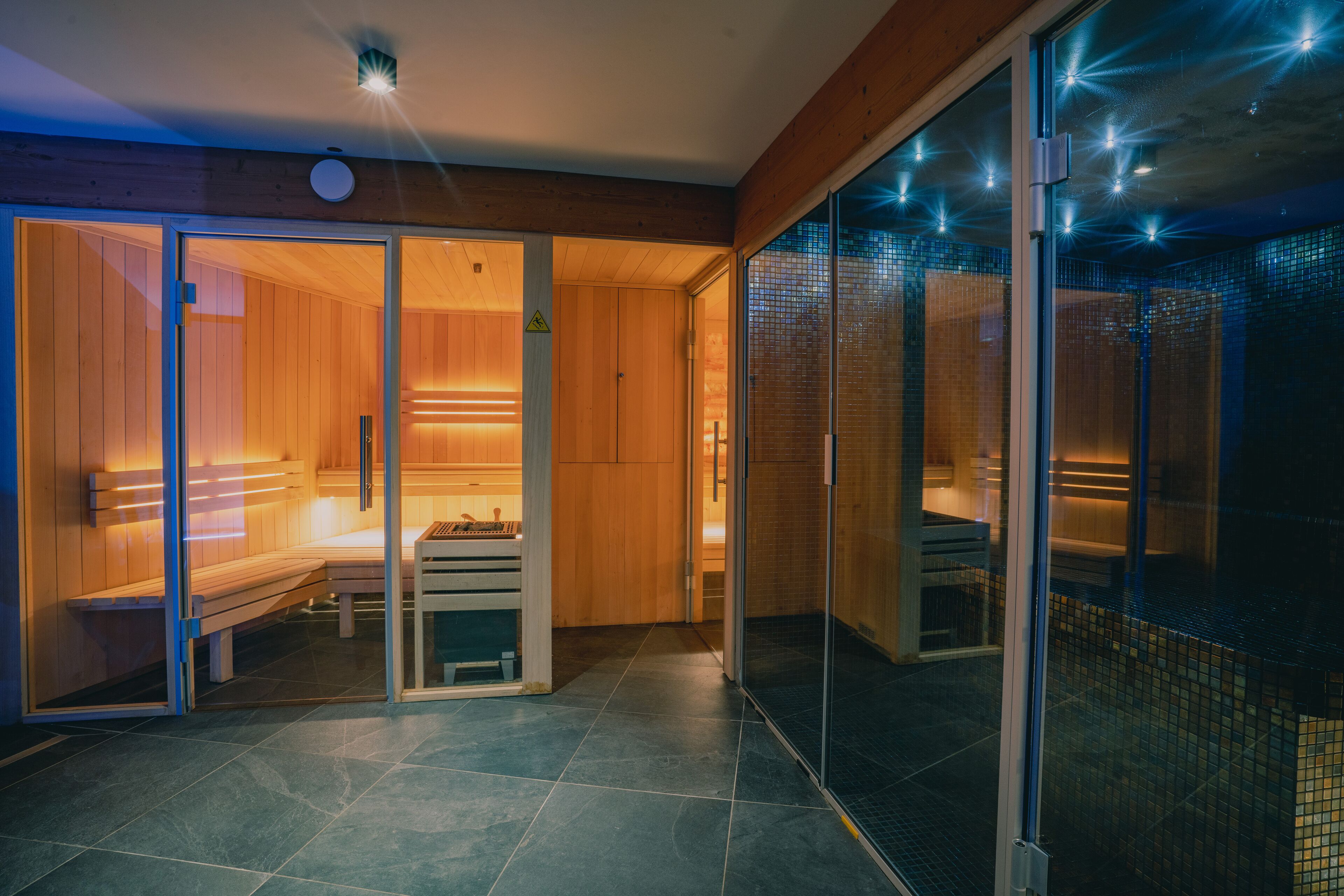 A sauna room with wooden benches and a bench with a towel.